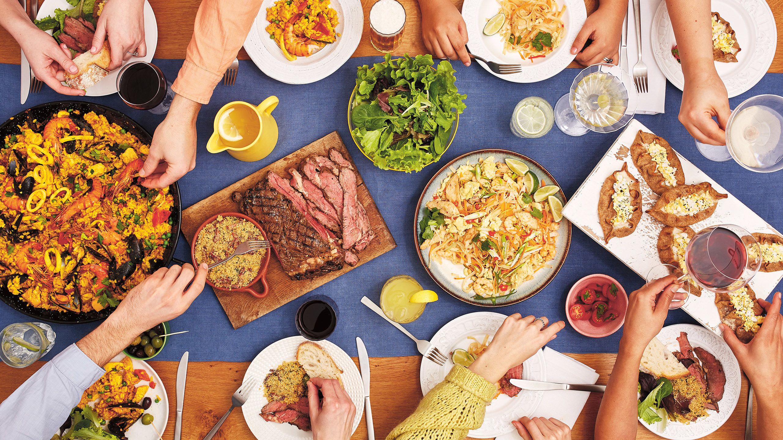 Feast - picture of a buffet with hands helping themsleves